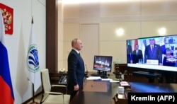 Russian President Vladimir Putin attends the Shanghai Cooperation Organization summit via a video link at his residence outside Moscow on September 17.