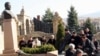 People offer memorial prayers at the tomb of late opposition leader Zamanbek Nurqadilov. (file photo)