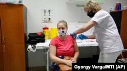 A nurse administers the Russian Sputnik V vaccine to a patient in Nagykanizsa on April 13.