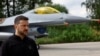 Ukraine's President Volodymyr Zelenskiy speaks to the media in a front of an F-16 after marking the Day of the Ukrainian Air Forces at an undisclosed location in Ukraine on August 4.
