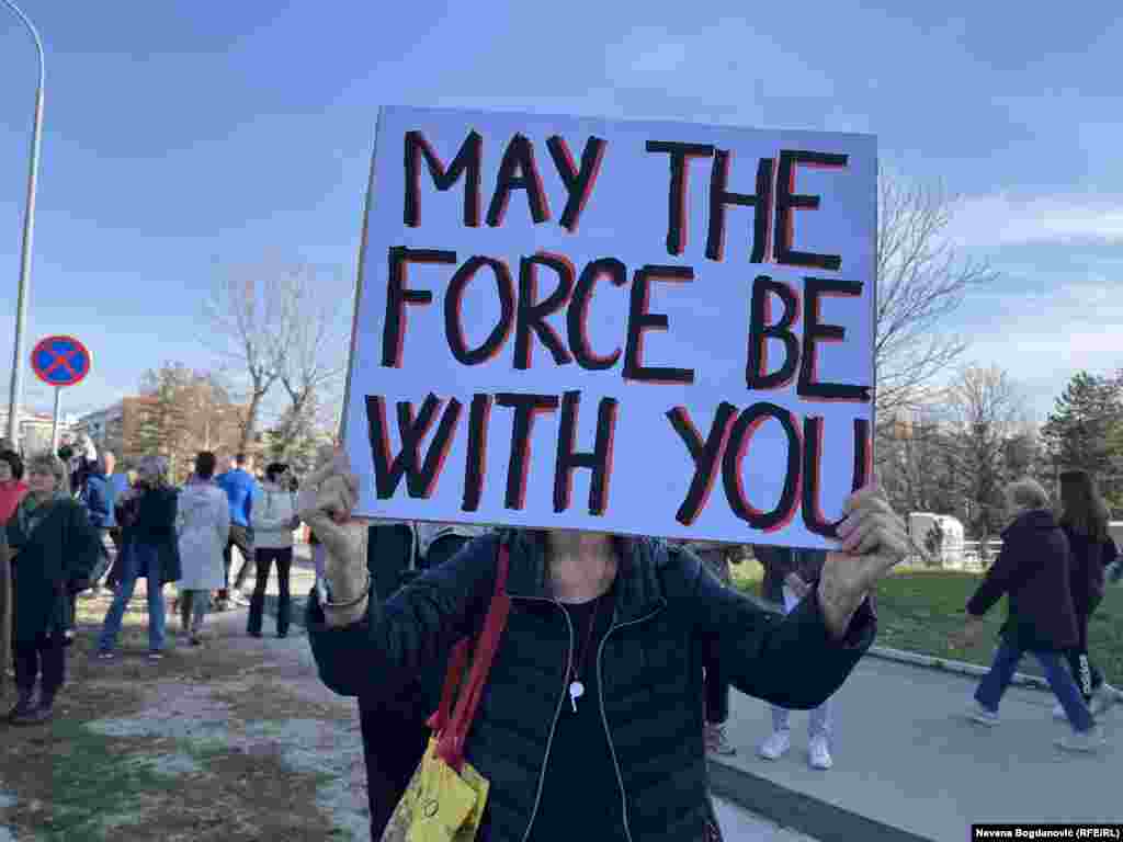 A protester carries a whistle and placard in Belgrade ahead of the march.&nbsp; Demonstrators say they will march to Novi Sad and join protesters there to blockade three critical bridges in the northern city.&nbsp;&nbsp; &nbsp;