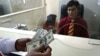 A customer counts his money after making a withdrawal at a branch of Aa bank in Kabul. (file photo)