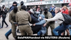 Law enforcement officers drag a demonstrator during a rally in support of detained Belarusian opposition leader Maryya Kalesnikava in Minsk in September 2020. 