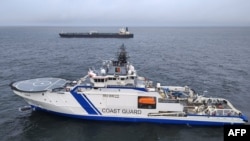 A Finnish Coast Guard vessel and the oil tanker Eagle S on the sea near Porkkalanniemi, Finland, on December 26.