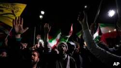 Iranian demonstrators chant slogans during an anti-Israeli gathering in front of the British Embassy in Tehran early on April 14.