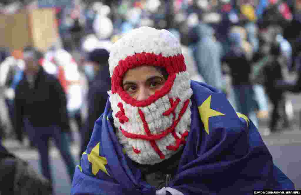 An opposition supporter attends a protest in front of Georgia&#39;s parliament building in Tbilisi.&nbsp;