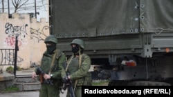 Armed men who are believed to be Russian troops on the streets of Simferopol.