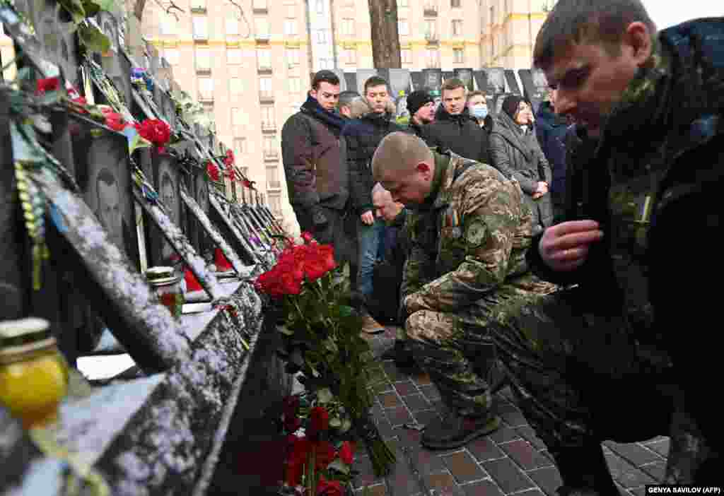 People with flowers and candles on February 18. Ukraine has indicted more than 200 people in connection with the deaths, but justice has been slow.