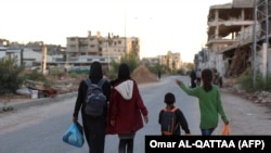 Displaced Palestinians, ordered by the Israeli army to leave the school in Beit Lahia where they were sheltered, arrive in Gaza City on October 19.