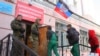 Armed security men guard a polling station during the elections in Donetsk on November 2.