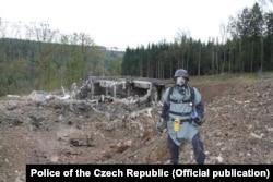 A pyrotechnician inspects a damaged ammunition depot near Vrbetice, Czech Republic, on October 20, 2014.