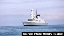 The British Royal Navy warship HMS Defender approaches the Black Sea port of Batumi on June 26.