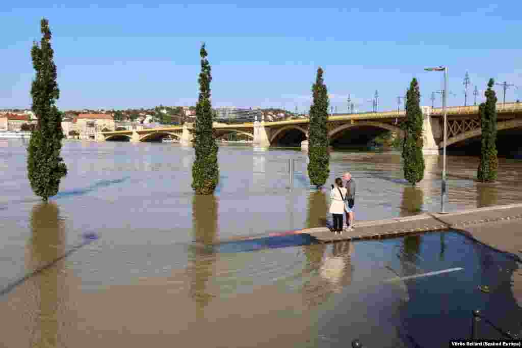 People observe the overflowing Danube near Budapest&#39;s Margaret Bridge.