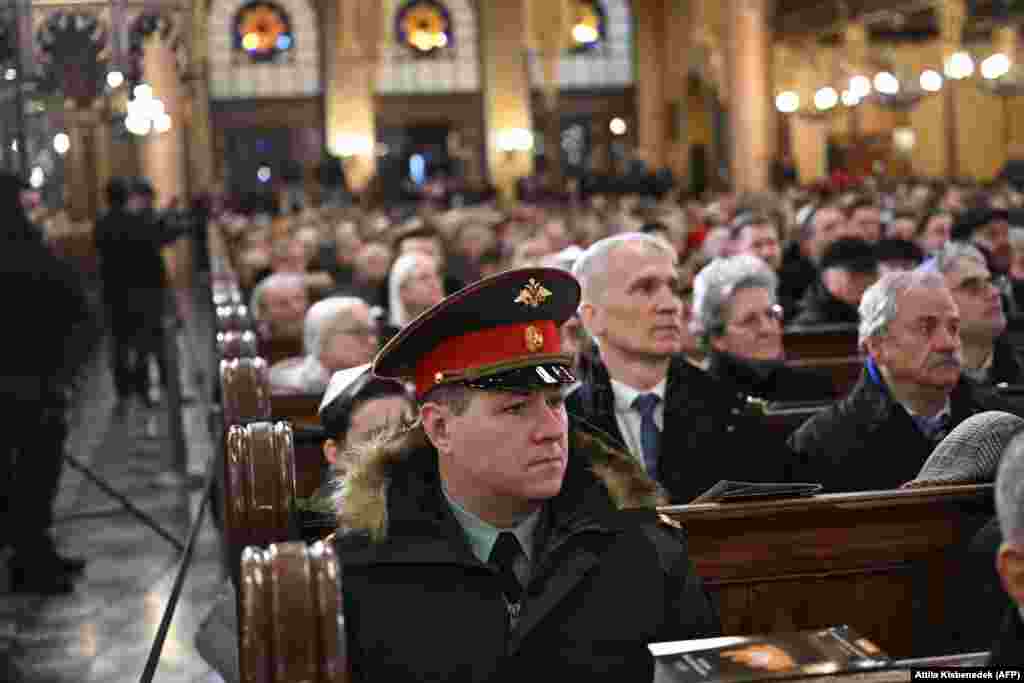 A Russian officer listens to a speech at a Budapest synagogue as people commemorated the 80th anniversary of the former Budapest ghetto&#39;s liberation during World War II.