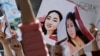 People hold placards during a rally in front of the Kyrgyz Interior Ministry in Bishkek in April 2021, demanding the resignation of its leadership after the killing of kidnapped bride Aizada Kanatbekova amid alleged inaction of police.