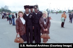 U.S. sailors wear souvenir Soviet hats as they pose with local women in Vladivostok in September 1992 during a three day “goodwill port call” by the U.S. Navy.