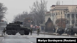 Kazakh soldiers stand guard at a checkpoint in Almaty on January 7.