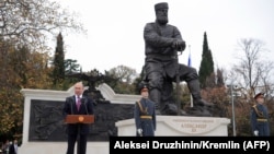 Russian President Vladimir Putin (left) delivers a speech during the unveiling ceremony of a monument to Tsar Aleksandr III in Yalta, Crimea, on November 18.