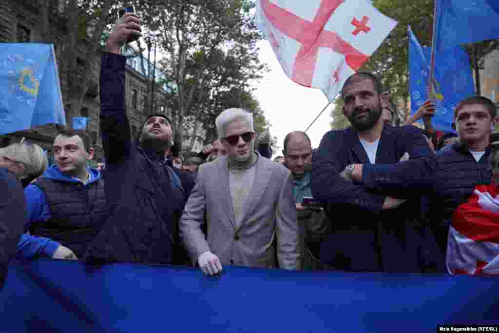 The son of Bidzina Ivanishvili, Tsotne Ivanishvili (center), and sportsman and deputy candidate Geno Petriashvili (second right) join the procession of supporters of the Georgian Dream before the start of the pre-election rally.&nbsp;