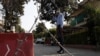 A Pakistani security official stands guard outside a residential area of Islamabad sealed off as part of the new smart lockdown after increasing numbers of coronavirus infections were reported.