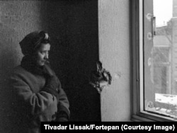 A women in a shrapnel-damaged apartment in early 1945.