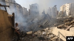 A man stands amid the rubble in Beirut's southern suburbs in the aftermath of Israeli air strikes.