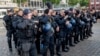 German police officers take off their caps in Mannheim after learning that an officer who was stabbed had died on June 2.