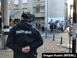 A police officer guards the Mladic mural from a nearby street corner on November 9, when opponents of its presence had pledged to cover it.