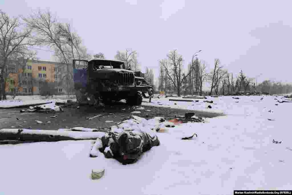 The burned-out hulk of a Russian Grad missile launcher and the body of a soldier near Kharkiv on February 25.