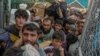 Afghans rush to pass through the border gate into Pakistan at Spin Boldak in September.