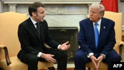 French President Emmanuel Macron (left) speaks with U.S. President Donald Trump at the White House on February 24.