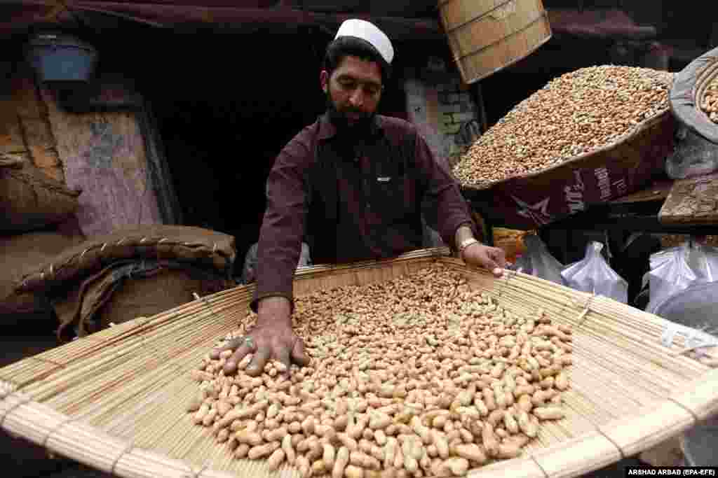 A vendor sells peanuts at a peanut market in Peshawar, Pakistan.