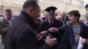 A screen grab of two men being arrested outside the U.S. Embassy in Moscow after they placed a sign at a makeshift shrine to the victims of a mass shooting in a gay nightclub in Florida. 