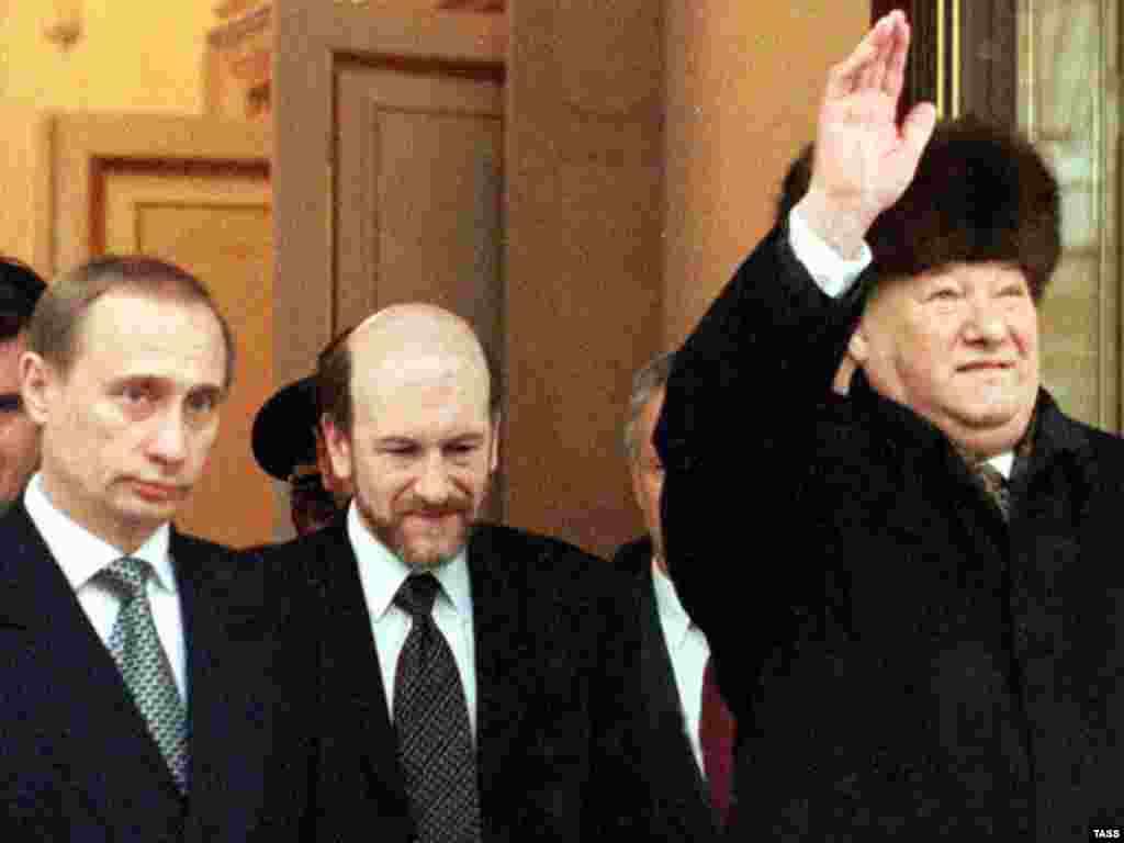 Yeltsin (right) waves as he prepares to hand over the presidential office to Putin (left) at the Kremlin in Moscow on December 31, 1999.