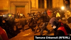 Police in Tbilisi advance with pepper spray against protesters during one of the recent anti-government rallies in Georgia. 