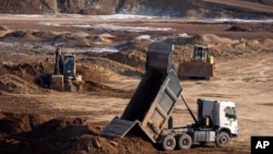 Workers extract the rare earth mineral ilmenite from an open pit mine in Ukraine's central Kirovohrad region. 