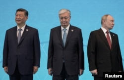 Chinese President Xi Jinping, Toqaev, and Putin (left to right) attend the Shanghai Cooperation Organization summit in Astana on July 4.