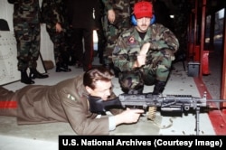 A Russian major general fires a U.S.-made M249 light machine gun at a U.S. Air Force base's firing range.