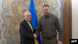 The head of President Zelenskyy's office, Andriy Yermak, shakes hands with U.S. Special Envoy Keith Kellogg in Kyiv on February 19.