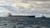 A handout photo released by the German Central Command for Maritime Emergencies on January 10 shows the tanker Eventin as a tugboat attaches a towing line. 