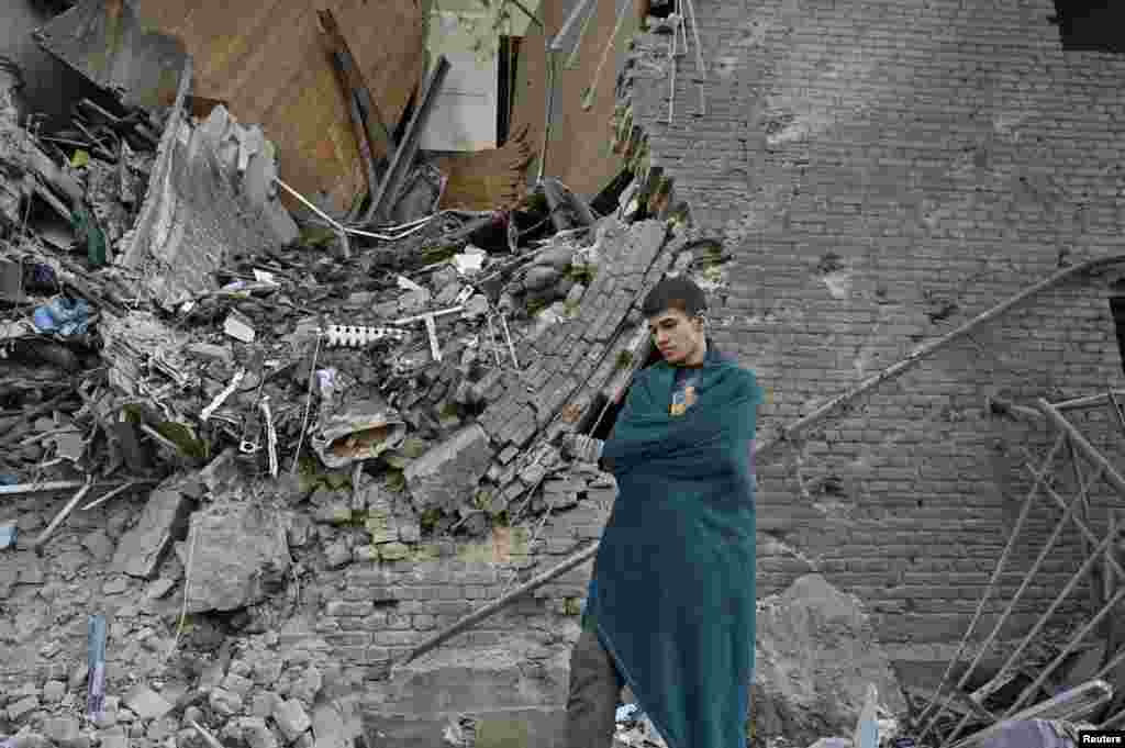 Vladyslav, 14, stands near his family&#39;s apartment in&nbsp;Zaporizhzhya after it was destroyed by a Russian glide bomb on September 29.&nbsp;