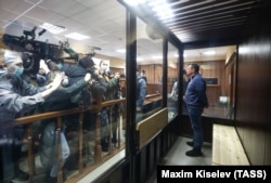 The director of the Listvyazhnaya coal mine, Sergei Makhrakov, seen inside a defendant's cage in a courtroom in Kemerovo, is accused of violating industrial safety rules that led to the deaths of the miners.