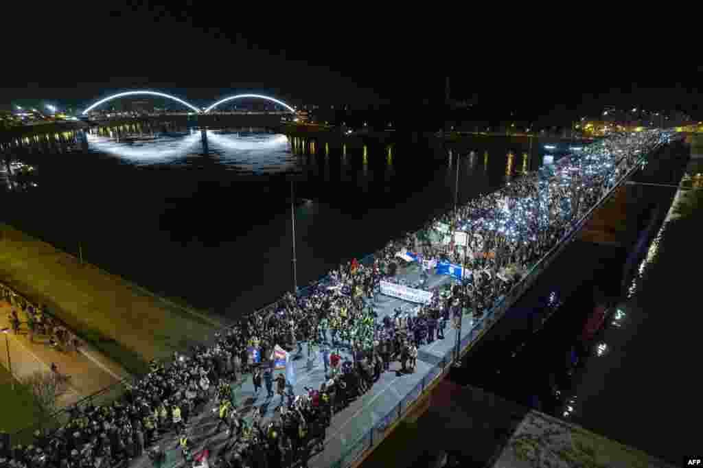 An aerial picture shows demonstrators using the torches of their phones during a 15-minute silence in Novi Sad to commemorate 15 people who died when a roof canopy collapsed in the city&#39;s railway station in November, an incident which has sparked protests across the country.&nbsp;