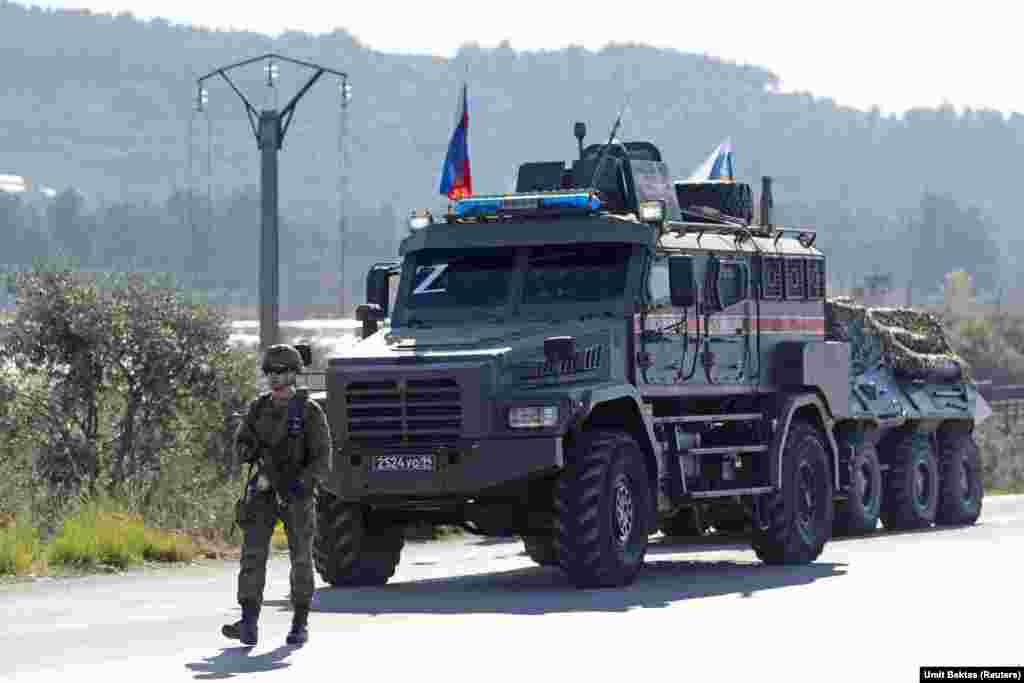 A Russian soldier guards a convoy that broke down on a road near the Hmeimim air base.&nbsp; &quot;There are a lot of convoys arriving,&quot; says Bektas. &quot;Some are awaiting transportation or something like that because you can see new tents [inside the base].&quot; &nbsp;