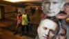 Masks depicting Russian President Vladimir Putin (top) and Russian opposition leader Aleksei Navalny for sale at a shop in St. Petersburg.