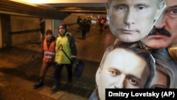 Masks depicting Russian President Vladimir Putin (top) and Russian opposition leader Aleksei Navalny for sale at a shop in St. Petersburg.