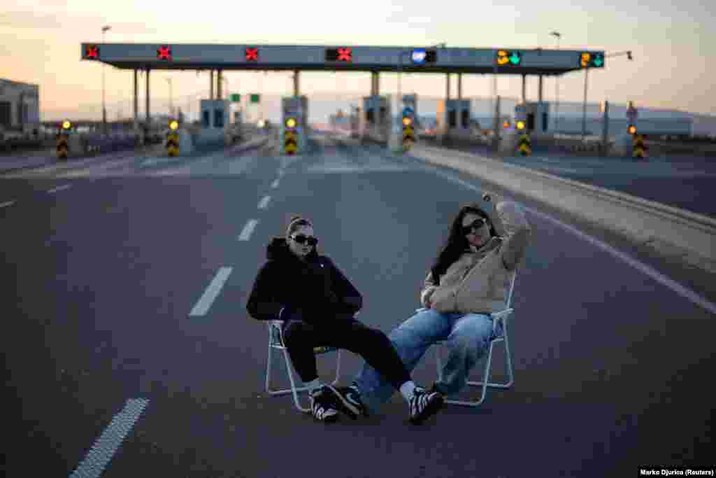 Demonstrators sit in front of the Nis-sever toll station during a protest over the fatal November 2024 Novi Sad railway station roof collapse in Serbia.