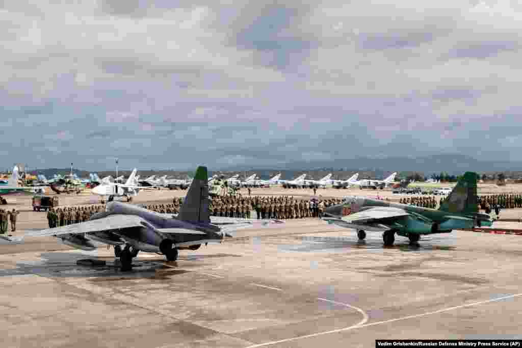 Russian personnel line up on the tarmac of the Hmeimim air base in March 2016. The British intelligence report cited &quot;Russia&#39;s prioritization of the Ukraine conflict&quot; as having &quot;degraded Russia&#39;s ability and capacity to keep the Assad regime in power.&quot;&nbsp; &nbsp;