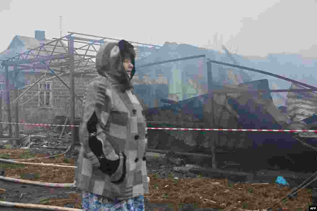 A local resident reacts near her neighbors&#39; house, which was destroyed by a drone strike in Kharkiv, on Christmas Day.&nbsp;