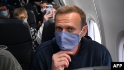 Aleksei Navalny travels on a flight back to Moscow on January 17. Analysts say a few arrests won't stop police and other law enforcement officers from monetizing their access to sensitive information.